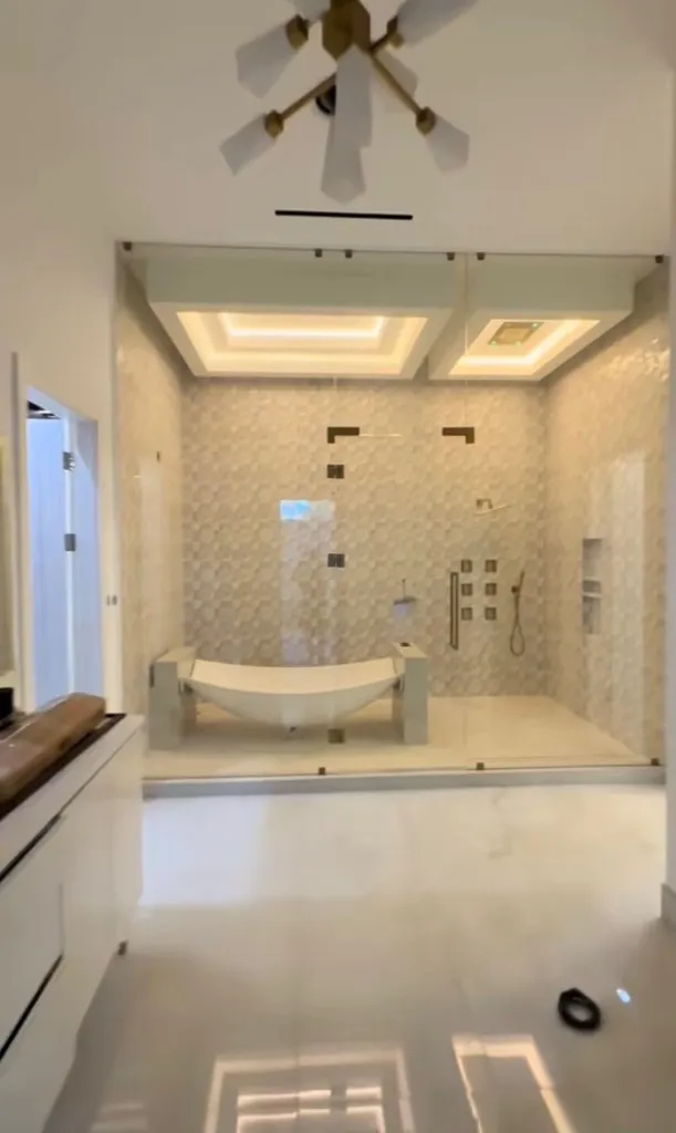 Custom bathroom with tiled shower, soaking tub, and finished millwork